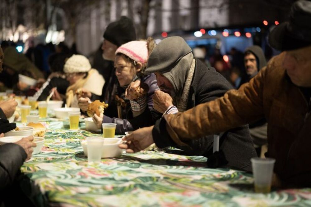 Personas en situación de calle cenando alimentos proporcionados por Red Solidaria. (Xinhua/Martín Zabala)