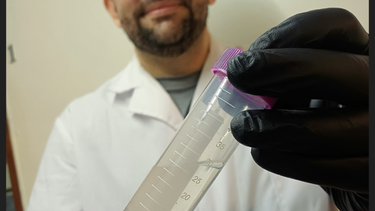 El Licenciado en Biotecnología Damian Ibarra sostiene una muestra de ADN disuelto, en el marco de la investigación.