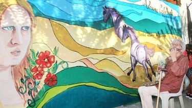 Ivis Mimí Vaio junto a un mural en homenaje a su hija Adriana Celihueta. (Ecos Diarios)