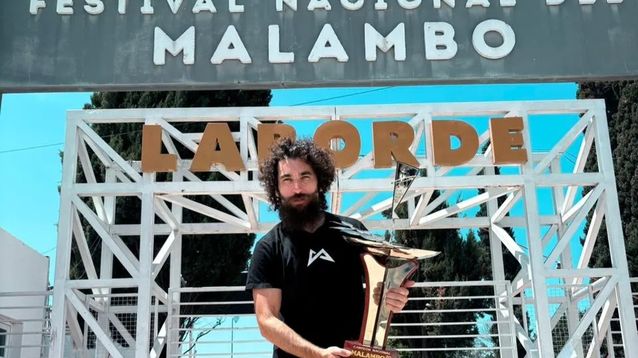 Matías Gallardo exhibe la copa en la entrada del Festival Nacional de Malambo 2026, en la ciudad cordobesa de Laborde.
