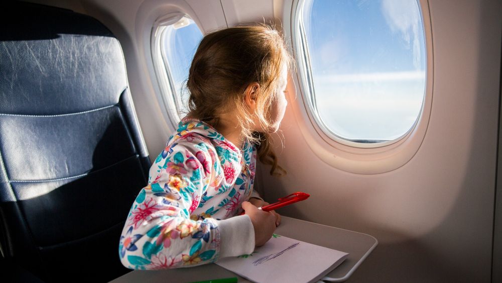 Una niña viajando en avión.&nbsp;