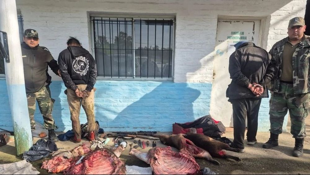 Los dos detenidos junto al cargamento decomisado.&nbsp;